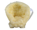 Yellow sheepskin foot scrubber on a white background