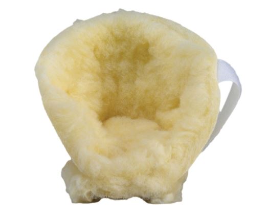 Yellow sheepskin foot scrubber on a white background